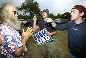 (Paul T. Erickson) Anti-Bush protestors Dan Teimouri, 18, right, and Dash Miller, 19, both of Kennewick exchange heated words with Dewayne Harvill of Burbank who supports Bush. The confrontaion happened in the parking lot of Hood River Park.