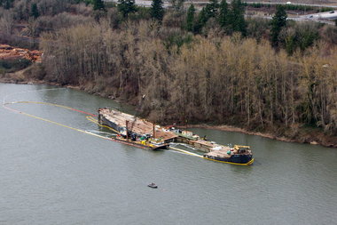 (Bruce Ely) The leaking Davy Crockett, mired in mud along the north shore of the Columbia River, earlier this year.