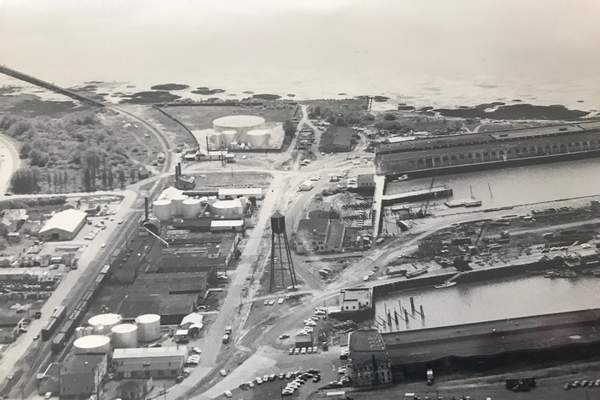 The Port of Astoria's central waterfront used to be populated with bulk fuel plants, seen on the left in this photo. An oil sheen in the Columbia River in the 1990s initiated a multimillion-dollar cleanup effort nearing a final solution.</p>(Clatsop County Historical Society)