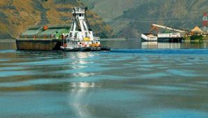 (Barry Kough) Barges designed for grain and wood chips, plus cargo container barges, use a slackwater river system that requires expensive maintenance, including dredging.