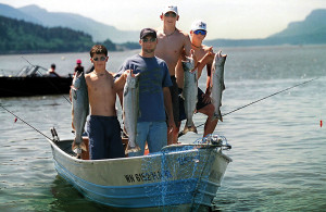 A small boat load of young anglers display their catch of Chinook salmon.