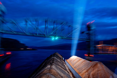 The Kathryn B, almost 600-feet long with her tow of three barges of wood chips, threads the needle-like passage under The Celilo Railroad Bridge on its journey from Lewiston, Idaho to The Port of Kalama.