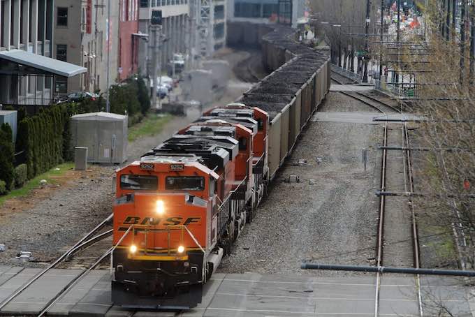 A coal train approaches SAM's Olympic Sculpture Park, Friday, April 26, 2013, in Seattle.