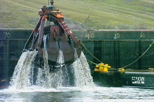 (Kyle Mills) A barge is loaded with silt when the Snake River was dredged in 2006.