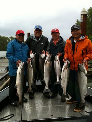 Fishermen display their catch of Chinook Salmon.