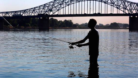 Ryker Durham, 18, of Kennewick, cools off during early summer morning bass fishing trip in Columbia Park on the Columbia River near the blue bridge. The Tri-Cities is under an excessive heat warning. (Bob Brawdy photo)