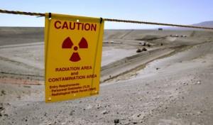 Workers walk on a blacktop covering leaking nuclear waste storage tanks seen during a tour of the Hanford Nuclear Reservation.  In recent weeks these tanks have been discovered to be leaking at a rate much higher than previously thought. (photo Joshua Trujillo)