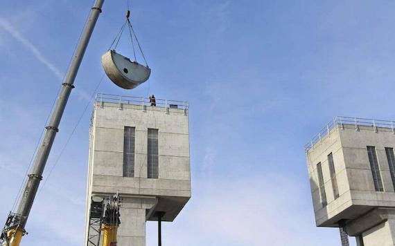 Half of a drum is lifted in early February back into place after maintenance in the south tower for navigation lock machinery at Ice Harbor Dam on the Snake River. Tri-City Herald file