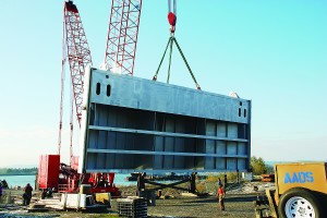 (Army Corps of Engineers) Crews from Advanced American Construction of Portland load the final quarter section of the new John Day navigation lock downstream gate onto a barge in Vancouver, Wash., on Nov. 23. The gate section is about 30 feet tall and 98 feet wide and weighs about half a million pounds.