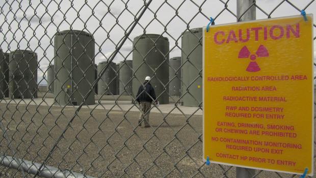 A worker walks around storage containers holding used nuclear fuel, Friday, May 7, 2010 at the Columbia Generating Station near Richland, Wash.