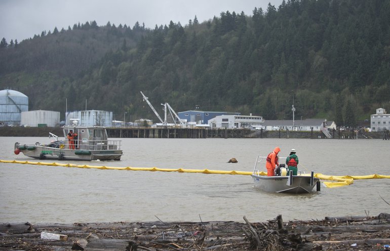 Crews deploy an absorbent boom on the Willamette River as part of an oil-spill training exercise in Portland last month. The Maritime Fire & Safety Association's worst-case disaster scenario involves a spill of 300,000 barrels of oil into the water. A proposed oil terminal at the Port of Vancouver would use vessels carrying as much 350,000 barrels of crude at a time. (Zachary Kaufman)