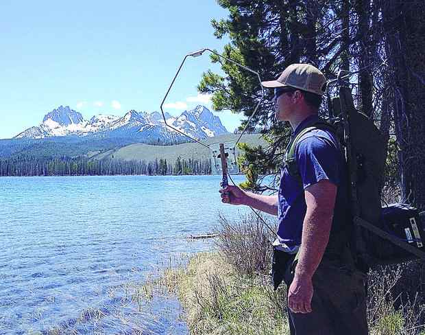 (Gordon Axel, NOAA) Technology is giving biologists the ability to get more data from more locations on spawning salmon. Here, Jesse Lamb, a scientist with the Northwest Fisheries Science Center, uses a mobile tracking device at Idaho's Little Redfish Lake.