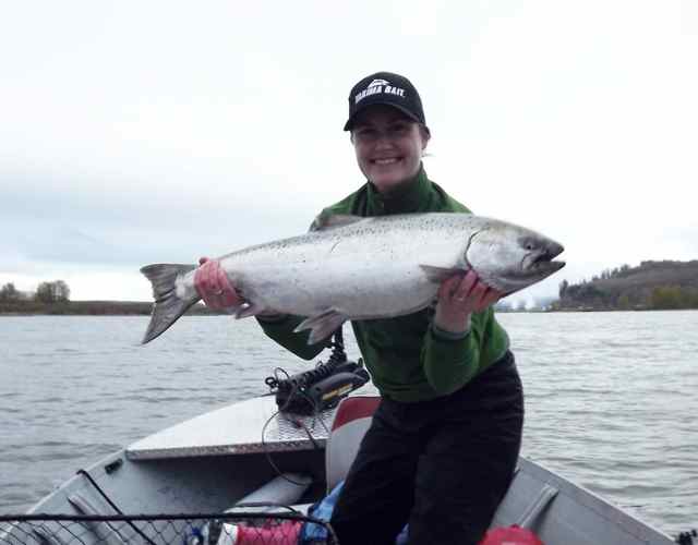 Erika Holmes holds a bright spring chinook she caught on the lower Columbia River. (Jeff Holmes)