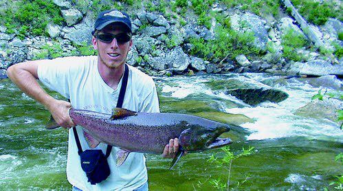 Lars Alsager holds a hatchery summer chinook from the South Fork of the Salmon River. The same strain of summer chinook is being introduced into the Clearwater basin, and is likely to produce a fishing season later this year. (Idaho Fish and Game)