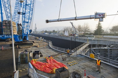 (Brent Wojahn) A crane this week moves into position a pipe that will be used to help drain the lock at The Dalles Dam in preparation for a 14-week shutdown that will affect it, another dam on the Columbia and one on the Snake. The $45.1 million maintenance project begins Friday.