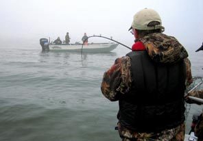 Joe Hymer, a state Fish and Wildlife biologist, reels in a spring chinook salmon on the Lower Columbia River.