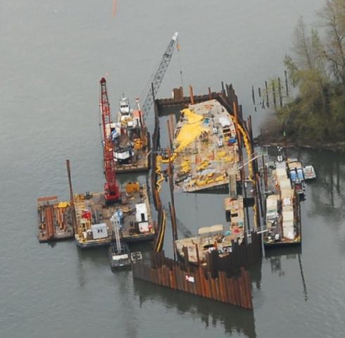 A cofferdam now surrounds the Davy Crockett, the leaky, half-sunken barge that is being dismantled and removed after dumping gallons of oil into the Columbia River.
