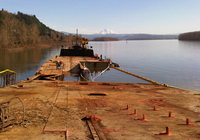 (WA Dept. of Ecology) The beached former Liberty ship Davy Crockett was run aground on the Columbia River near Camas last week. Structural instability is complicating efforts to locate the source of oil leaking from the vessel.