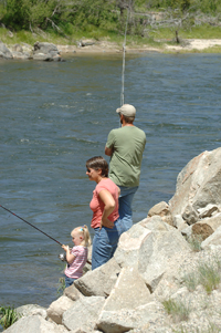 (Willy Cook) Four-year-old Hailey angler Alexis Burk, standing next to Gaylynn and Rick Burk, fishes for chinook salmon along the upper Salmon River downstream of Stanley last summer. The Burks were taking part in the first chinook season along the upper Salmon in 31 years. This summer, local anglers may get another chance to pursue the popular gamefish in the Stanley area, according to fisheries officials with the Idaho Department of Fish and Game.