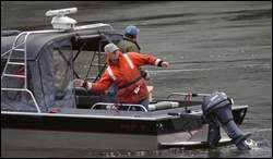 (AP) Devices are thrown into the water during a sea lion hazing experiment near Bonneville Dam outside North Bonneville, Wash., in 2005.