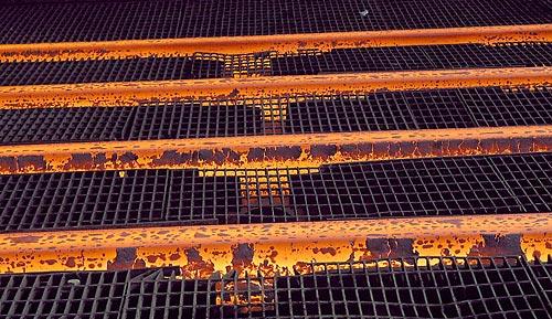 After scrap metal is melted down, the molten steel is distributed into four separate streams, which then go into copper molds.
