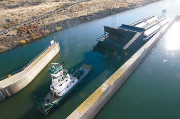 (Andy Porter/Union Bulletin) A 1,000-ton removable fish weir is guided into the navigation lock at Lower Monumental Dam late Tuesday afternoon. The weir arrived from Portland and will be installed in coming days.