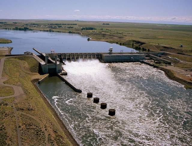 Water pours through the Ice Harbor Dam on the Snake River east of 
Pasco. It is one of four lower Snake River dams covered in an environmental review that will look at whether removing the dams is the best option to improve salmon runs.