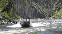(Darin Oswald) A jet boat glides up the Salmon River, negotiating the river currents and whitewater.
