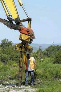 (Kyle Mills) -- Wildland Inc. worker Jose Alvarez loaded one of nearly 8,000 native plants into an expandable stinger attached to an excavator as part of a Lapwai Creek restoration project designed by the Nez Perce Tribe, BPA and NOAA Fisheries, in Lapwai, Idaho, May 17. The trees and shrubs being planted 40 acres along Lapwai Creek near Sweetwater will hopefully increase salmon habitat there.
