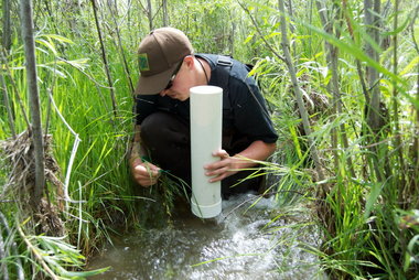 (Scott Learn) Josh Dowdy, 24, practices surveying pebbles and other river-bottom particles in a stream that feeds the Columbia River near Brewster, Wash. The pebble measuring helps determine whether a stream is good for spawning or growing young salmon.