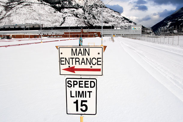 (Lido Vizzutti) A sign directs traffic around the nearly empty parking area at the Columbia Falls Aluminum Company building in Columbia Falls.