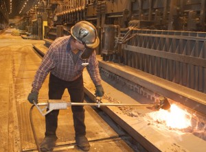 A CFAC worker seals the crust on one of the smelter plant's  600 aluminum reduction pots in this file photo from 2005.