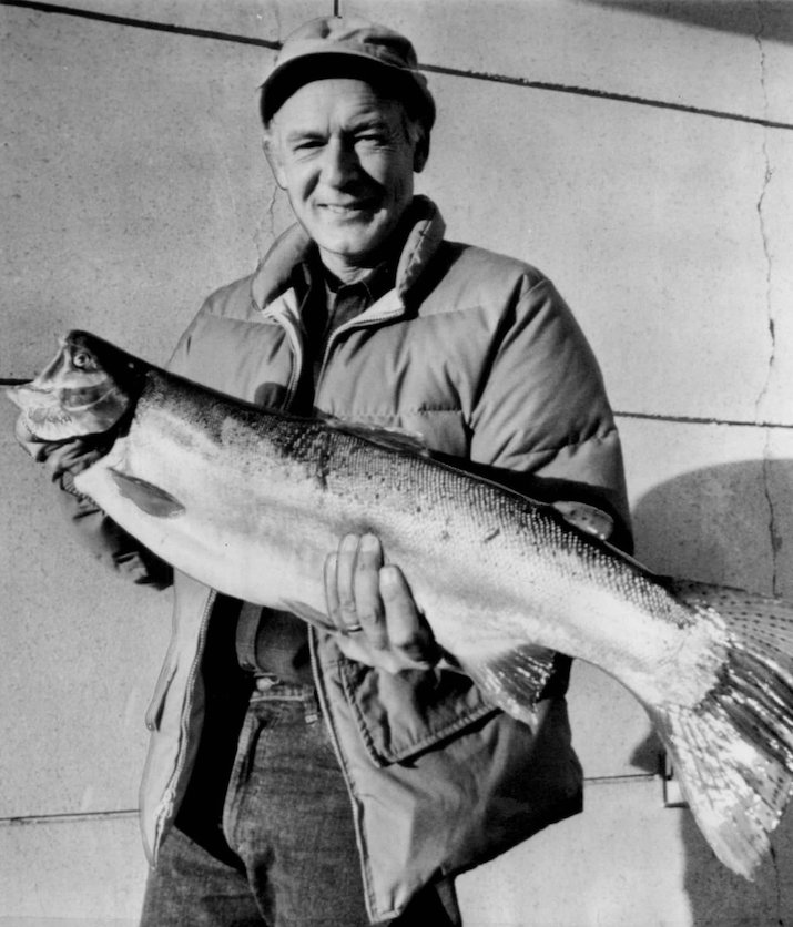 Idaho's governor Cecil Andrus holds a 12-pound steelhead he caught during his annual one-day outing on the Clearwater River in 1974. 
