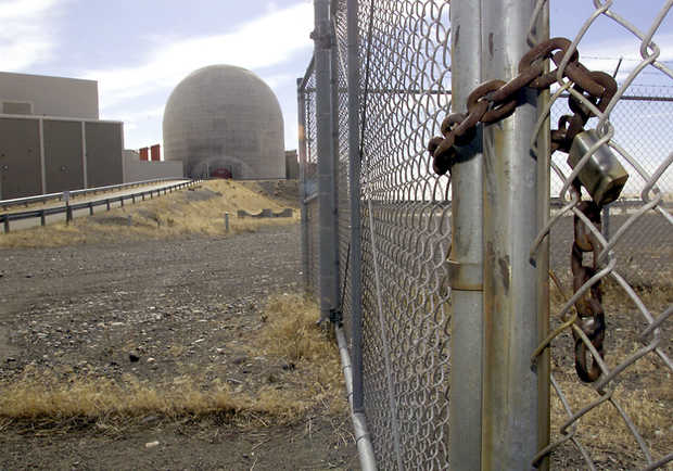 A padlock secures a gate to Energy Northwest's nuclear plant No. 1 at Hanford, which was closed after being 60 percent completed when it was determined in the 1980s that the additional power wasn't needed. (Tri-City Herald File)
